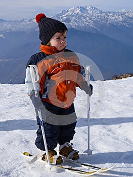 3-year-old child on the snow learns to ski