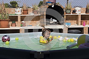 3-year-old girl plays in the pool