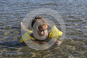 3-year-old girl swims in the Mediterranean sea