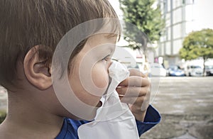 3 years boy blows his nose with tissue