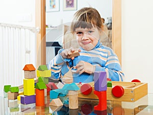 3 years child playing with toys in home
