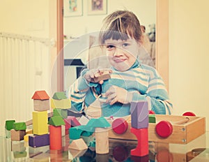 3 years child playing with toys in home