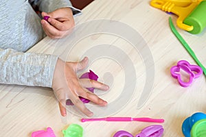 3 years girl creative arts. Child hands playing with colorful clay. Plasticine. play dough. Self-isolation Covid-19, online