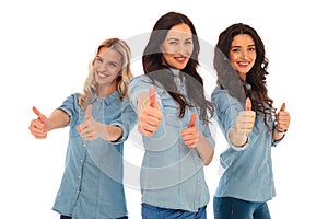 3 young casual women making the ok thumbs up sign