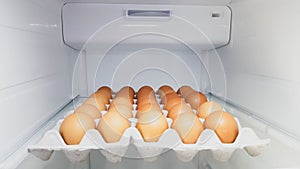 30 eggs in a carton box in the fridge.