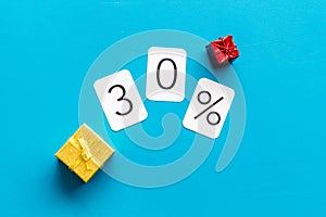 30% off discount - sale concept with present box - on blue background top-down copy space