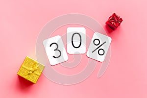 30% off discount - sale concept with present box - on pink background top-down copy space