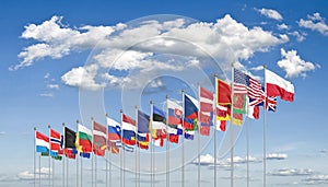 The 30 waving Flags of NATO Countries - North Atlantic Treaty. Isolated on sky background  - 3D illustration