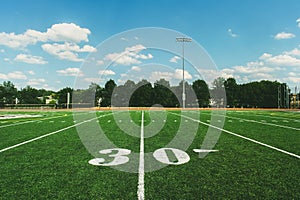 30 Yard Line on American Football Field and blue sky