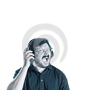 30 years old caucasian man singing loud song and listen music from Headphones. Blue color effect