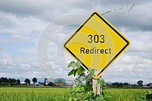 303 Redirect street sign and rices field in the background