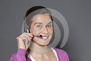 30s beautiful businesswoman thrilled to use a headset as a phone