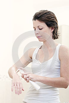 30s Woman Applying Moisturising Cream