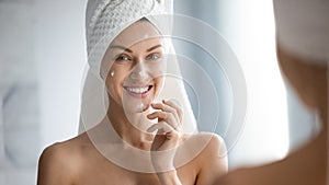 30s woman after shower apply moisturiser for dehydrated skin