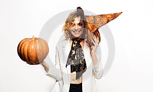 31 October. Halloween party. Smiling woman in witch hat with pumpkin. Preparation Halloween holidays. Sexy woman witch