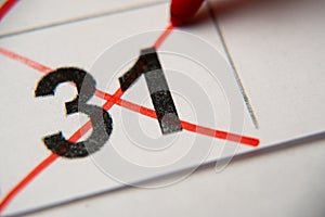 The 31st number in the calendar is crossed out with a red cross in a macro on a white sheet. Calendar for plans, notes