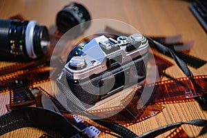 35mm Film Camera surrounded by Film negatives