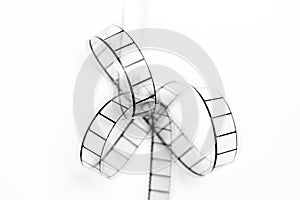 35mm movie film bow closeup, black and white on white background