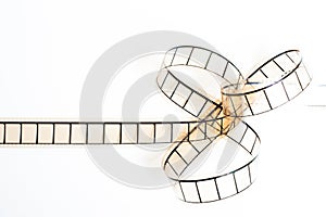 35mm movie filmstrip, film bow on white background