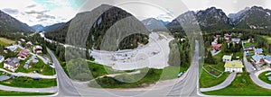 360 degrees aerial view of alpin town in summer season. Dolomite Mountains