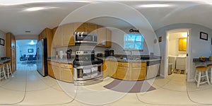 360 equirectangular photo of a kitchen with view of laundry and dining area