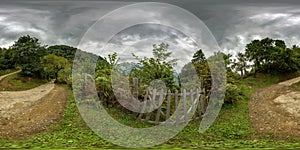 360 hdri panorama on serpentine path near old wooden fence in high in mountains among deciduous forest in equirectangular