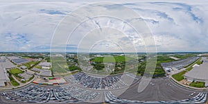 360 panorama by 180 degrees angle seamless panorama of aerial top view of new cars parking for sale stock lot row, dealer