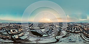 360 panorama of Sun shining over winter city with sun rays hitting the building