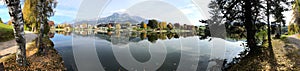 360 Saalfelden ritzensee with still reflecting water  mountain with clouded tops