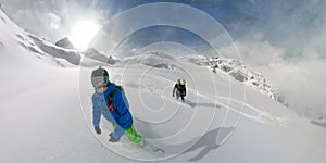 360 VR: Active female and male tourists snowboarding off trail in the Rockies.
