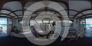 360 VR Family traveling by yacht. Inside view with captain driving vessel