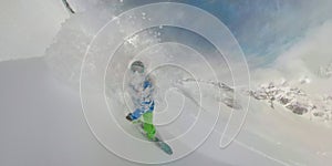 360VR: Extreme snowboarder spraying powder snow around him as he rides off piste