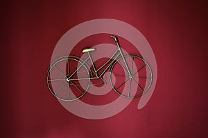 3D bicycle wall decoration. Stylized bicycle on a red wall.