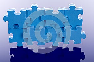 3D blue puzzle on blue background.