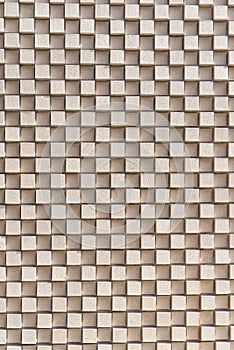 A 3D checkerboard pattern of beige bricks