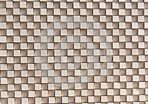 A 3D checkerboard pattern of beige bricks