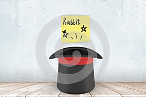 3d close-up rendering of black top hat on wooden floor near wall with yellow sticky note that reads `Rabbit`.
