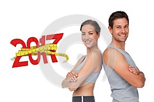 3D Composite image of portrait of a happy fit young couple with hands crossed