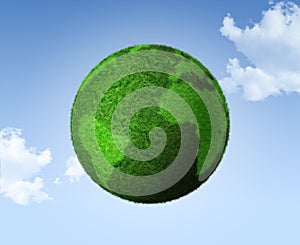 3D green grass globe on a blue sky