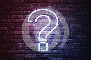 3D illustrated question mark with led light on brick wall background.