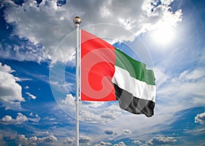 3D illustration. Colored waving flag of United Arab Emirates on sunny blue sky background