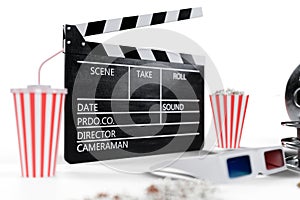 3D illustration, director chair, movie clapper, popcorn, 3d glasses, film strip, film reel and cup with carbonated drink