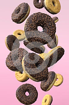 3D-illustration of flying donuts on pink background.