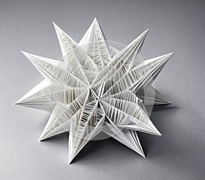 A 3D origami star made of white paper.