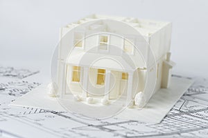 3D plastic model of the family house without roof printed on a 3D printer with white filament by FDM technology for