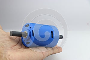 3D printed dc motor with dual shaft made from PLA filament material held in the hand