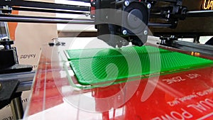 3D printer. 3d printer printing close-up. Molten plastic flowing out of extruder