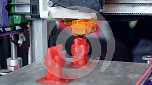 3D printer. 3d printer printing close-up. Molten plastic flowing out of extruder