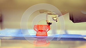 3D printer printing an object from plastic.