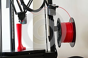 3d printer printing plastic last shoe prototype from red filament